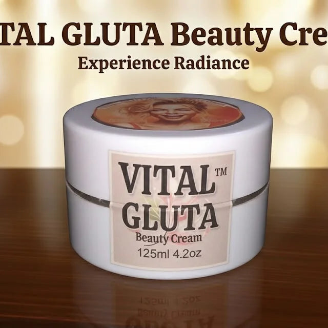 A white jar of VITAL GLUTA Beauty Cream sits on a dark wooden surface against a warm, blurred golden bokeh background. Text at the top reads 'VITAL GLUTA Beauty Cream' and 'Experience Radiance'.