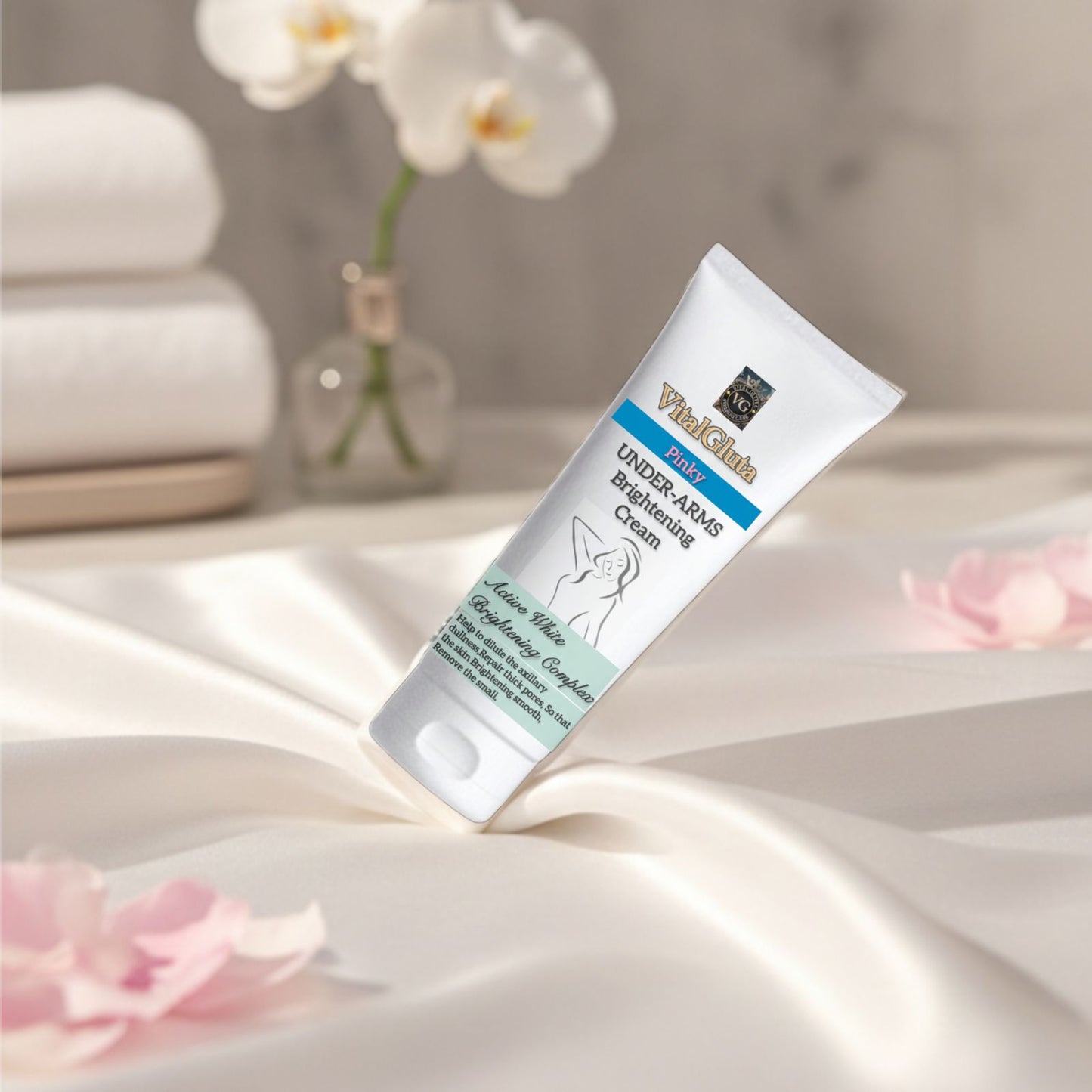 Tube of pinky brightening Under Arms Brightening Cream on a satin surface with flowers in the background